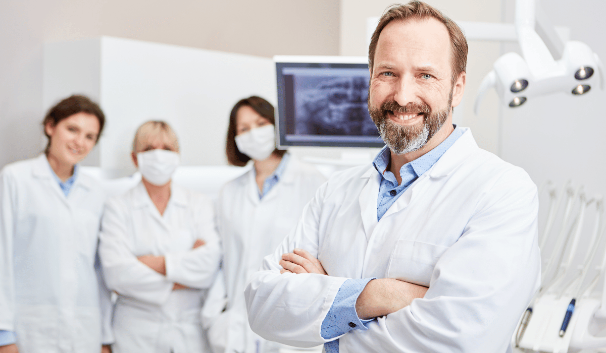 Great Smiles Dentistry: a dentist and three clinical staff in white coats in a treatment room